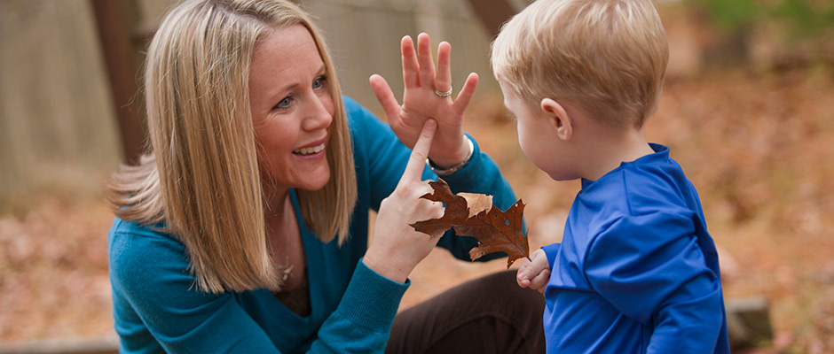 Mother using sign language with toddler boy - Decibels Foundation
