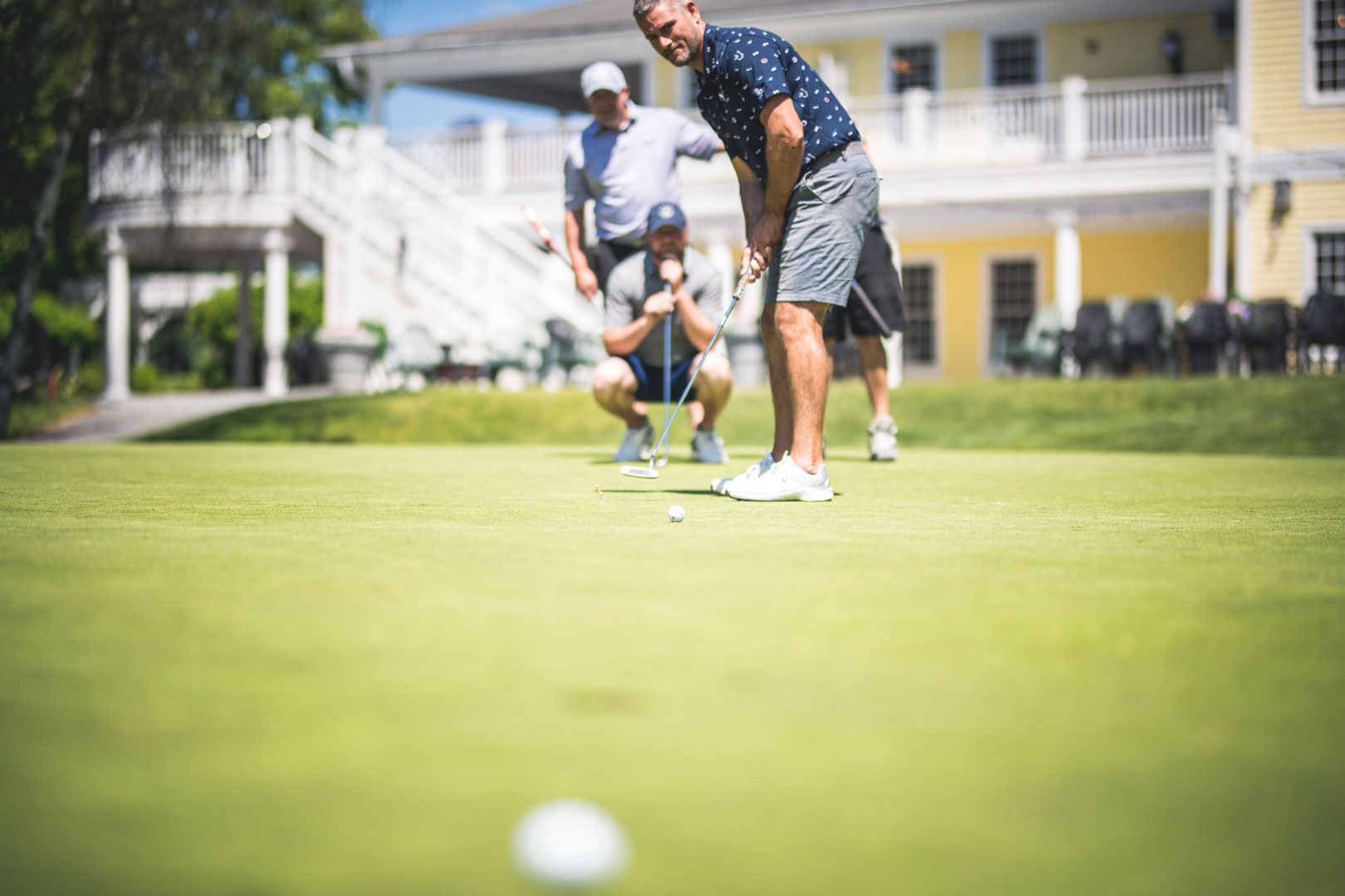 Men playing golf - Decibels Foundation